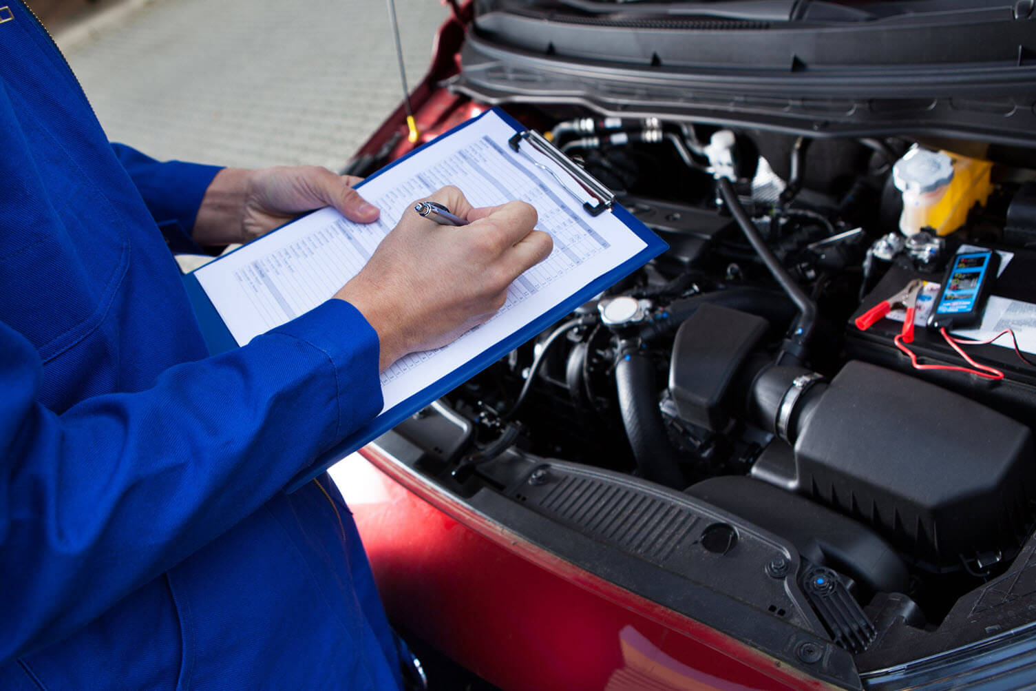 mechanic checking car engine